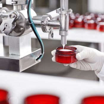 worker-filling-container-with-cream-cosmetic-factory