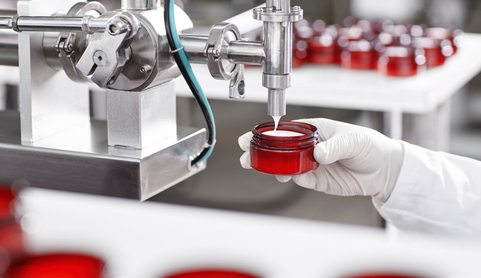 worker-filling-container-with-cream-cosmetic-factory